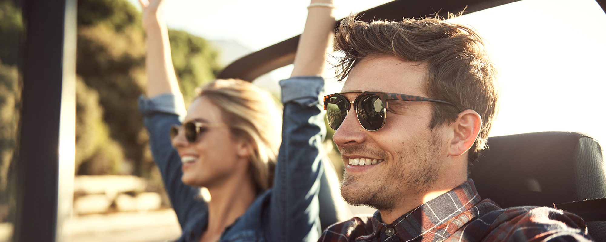 Couple Driving Wearing Sunglasses